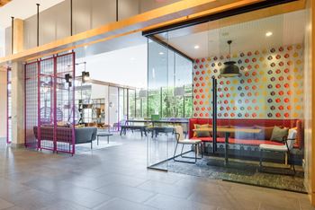 A lobby with furniture and a large glass wall